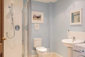 The spacious en suite has a handy washing machine, as well as large shower cubicle.