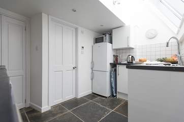 Access to the ground floor bathroom is through the kitchen.
