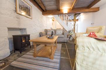 An electric wood-burner effect stove warms the sitting-area.