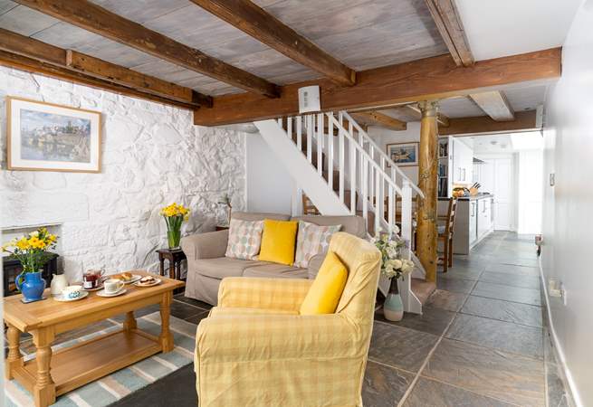 The ground floor living area has characterful beams and traditional stonework walls.