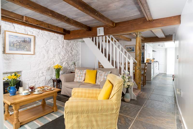 The ground floor living area has characterful beams and traditional stonework walls.