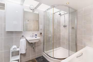 The stylish bathroom has a bath and a walk-in shower.
