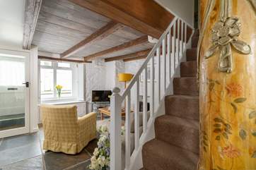 Characterful touches throughout include this ancient column at the bottom of the staircase.