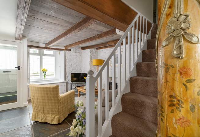 Characterful touches throughout include this ancient column at the bottom of the staircase.