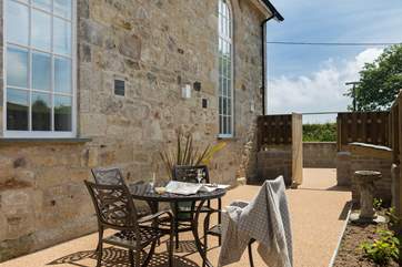 A tucked-away spot for morning coffee and evening meals on summer days.
