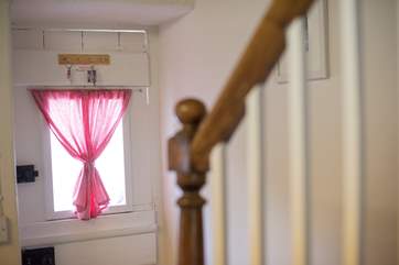Steep stairs lead up to the shower-room and bedrooms.