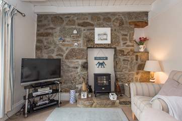 A large TV and the glow of the stove.