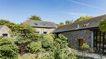 Laurel Cottage (situated to the left) through the beautiful greenery.
