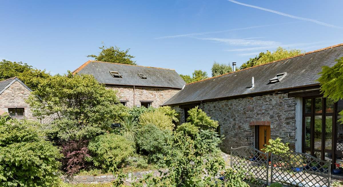 Laurel Cottage (situated to the left) through the beautiful greenery.