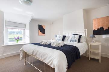 The master bedroom has views over the harbour and coastline.