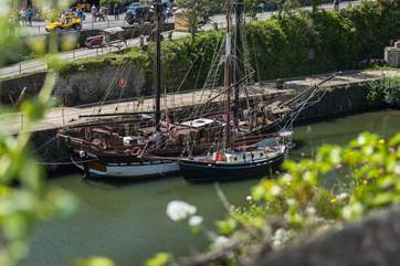 The tall ships sitting in the harbour.