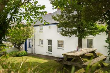 The garden is to the rear of the farmhouse.