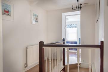 The landing with doors to both bedrooms and the bathroom.