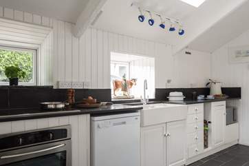 The kitchen leads through to the larder, cloakroom and the back door into the garden.