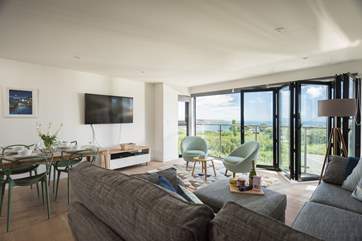 The apartment has a large corner sofa to relax on whilst watching a movie on the Smart TV.