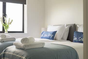 Crisp white linens on comfy quality mattresses make for a good night's sleep.