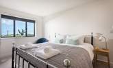 The gorgeous king-size bed with fresh cotton sheets and white fluffy towels awaits you. - Thumbnail Image