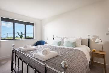 The gorgeous king-size bed with fresh cotton sheets and white fluffy towels awaits you.