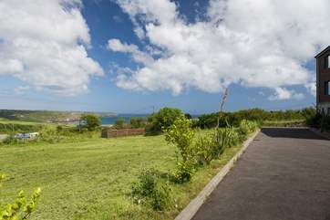 There is a shared lawn next to the building, a perfect spot for relaxation and playtime.