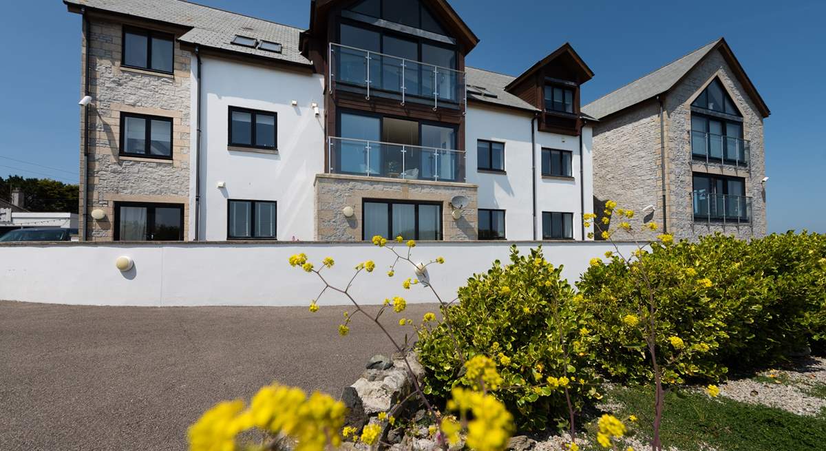 There are only eight apartments in the building making them rather exclusive. The apartment is on the first floor, in the middle of the photo with the windows open.