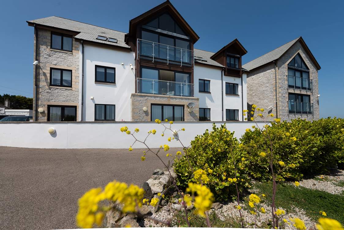 There are only eight apartments in the building making them rather exclusive. The apartment is on the first floor, in the middle of the photo with the windows open.