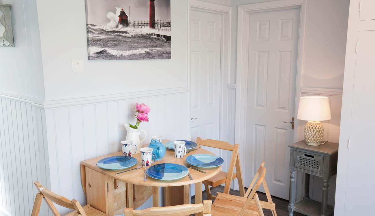 There is a small dining-room table that can seat four and can be folded away for convenience and additional space.