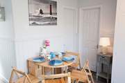There is a small dining-room table that can seat four and can be folded away for convenience and additional space.