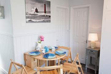 There is a small dining-room table that can seat four and can be folded away for convenience and additional space.