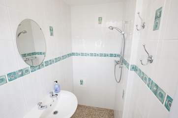 After creating footprints on the sand, wash it away from inbetween your toes in the walk-in shower.