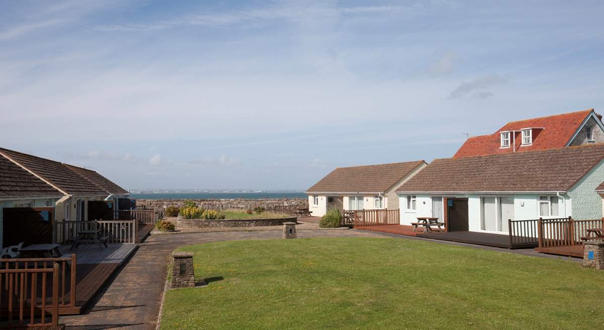 To the back of Cockleshells is a shared lawn-area which is a great space for children and dogs to run around.