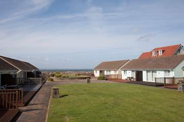 To the back of Cockleshells is a shared lawn-area which is a great space for children and dogs to run around.