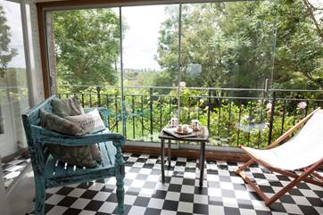 At the back of the house is the mediterranean style sun-room, with lovely views to the back garden and fields beyond.