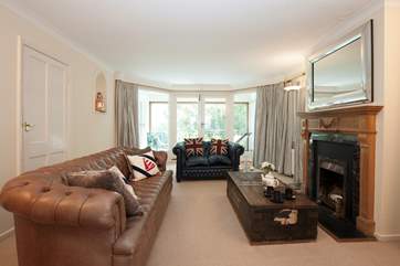 The comfortable and stylish living-area with ornamental fireplace is a great place to spend the evenings.