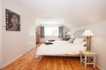 The master bedroom is certainly impressive in size and style with beautiful wooden floors adding to the charm.