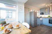 Enjoy your morning breakfast whilst glazing out at sea views in the  modern style kitchen/breakfast-room.