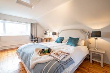 The spacious main bedroom on the first floor overlooks the garden.