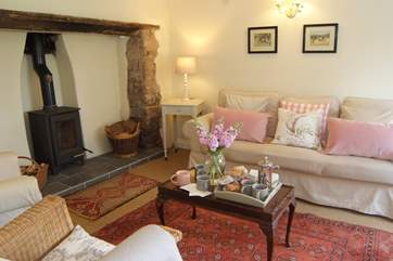 The wonderful welcoming sitting-room has an inglenook fireplace and a wood-burning stove.