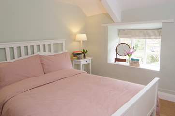 This is the main bedroom with its king-size bed and pretty views to the front of the cottage