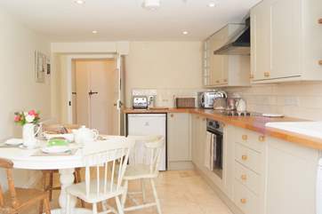 This is another view of the kitchen. Beyond it is a downstairs WC and a utility-area, and then the back door.