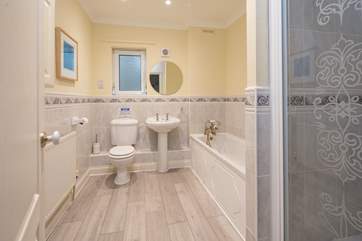 Family bathroom on the first floor comprises of a bath and a shower cubicle.