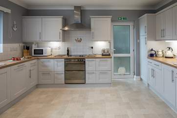 Spacious and well-equipped kitchen, which leads out onto the decked area.
