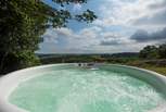 There is even a bubbling hot tub with spectacular far reaching views across the valley and countryside beyond.