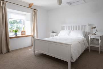 Bedroom 1 is at the front of the cottage, overlooking the parking space and small road.