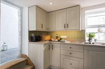 A low doorway (mind your head!) leads from the kitchen to the rear garden.
