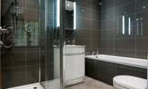 Bedroom 1 has a modern en suite with a bath and separate shower. - Thumbnail Image