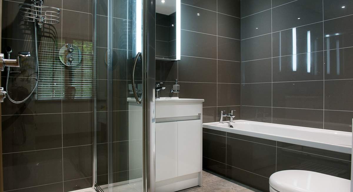 Bedroom 1 has a modern en suite with a bath and separate shower.