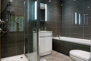 Bedroom 1 has a modern en suite with a bath and separate shower.