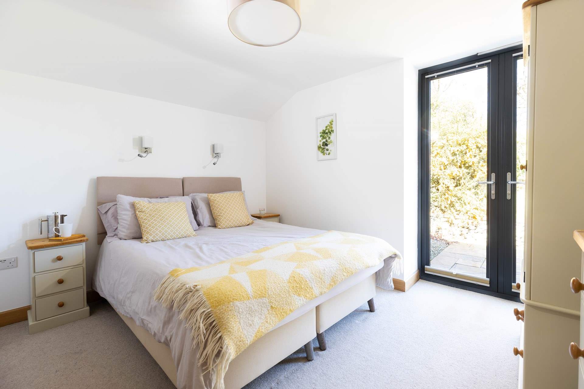 Double doors open to the sheltered garden.