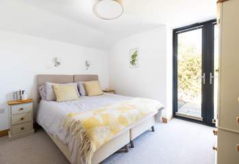 Double doors open to the sheltered garden.