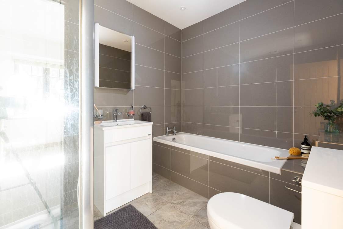 The en-suite bathroom for bedroom 1 has a shower and separate bath.